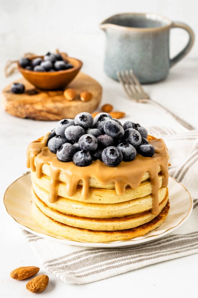 Sourdough Banana Pancakes topped with almond butter and blueberries