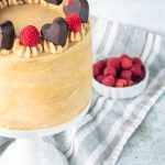 Peanut Butter and jelly cake, topped with chocolate hearts and raspberries