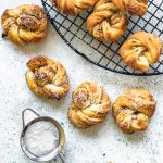 Cardamom Walnut Pastries, small pastries with a powdered sugar sifter
