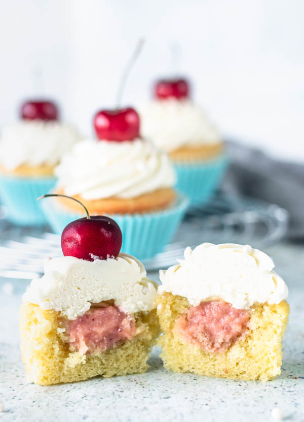Cherry cupcakes cut in half with cherry filling