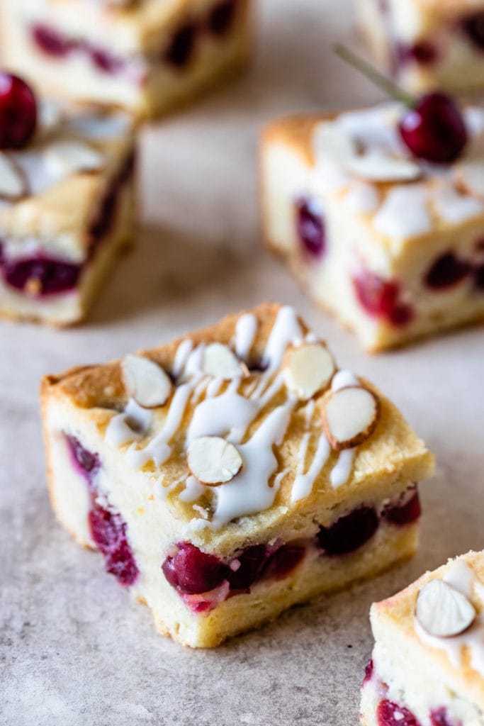 cherry bars topped with almond glaze and sliced almonds