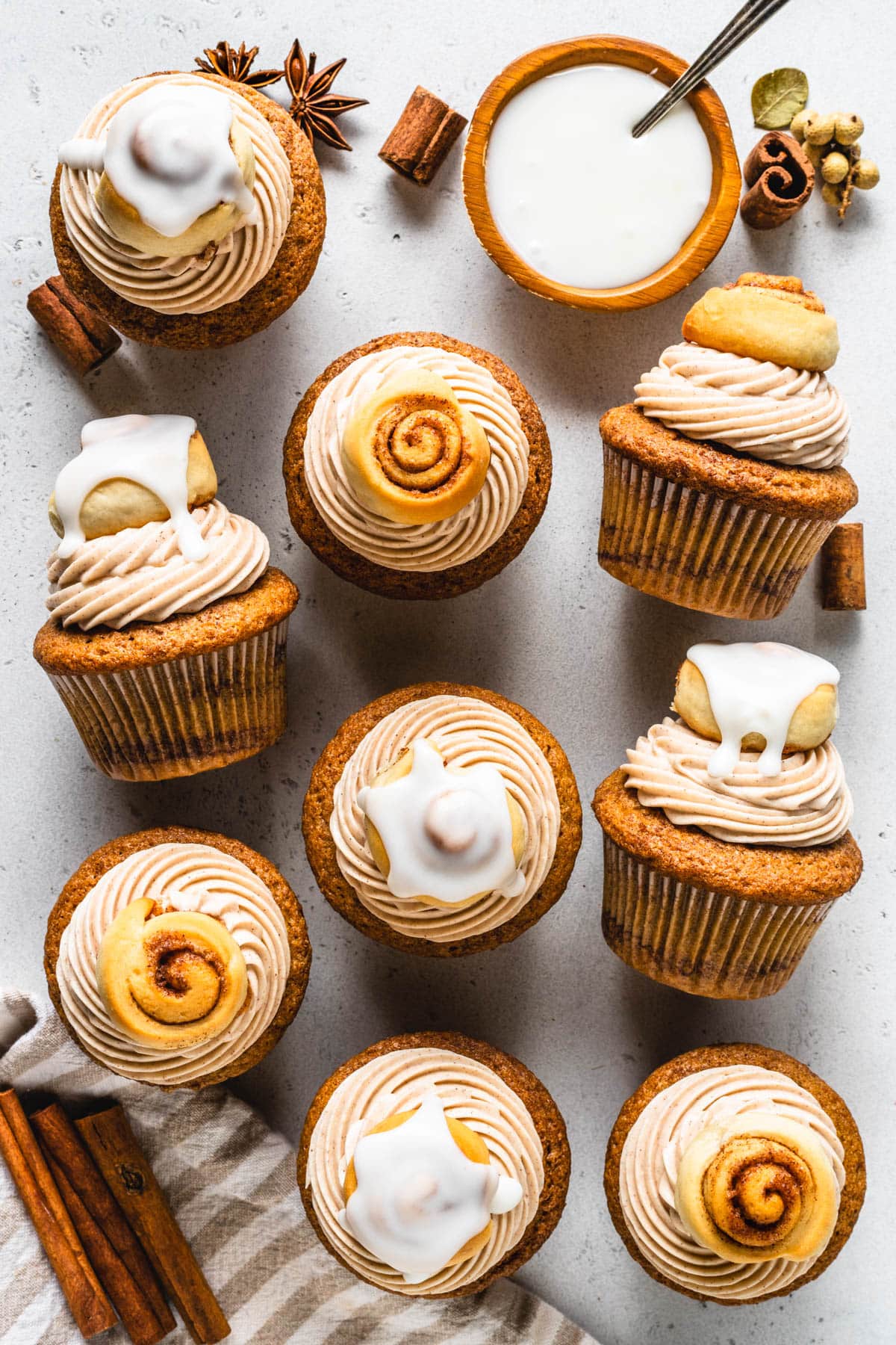 Cinnamon Roll Cupcakes topped with a glazed mini cinnamon roll seen from the top.