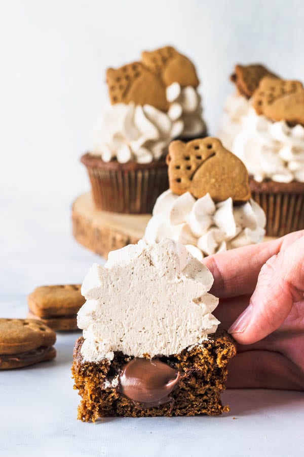 Nutella Gingerbread Cupcakes filled with nutella sliced in half, topped with a gingerbread swiss meringue buttercream.