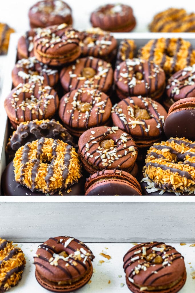 samoa macarons shaped like donuts filled with toasted coconut caramel.