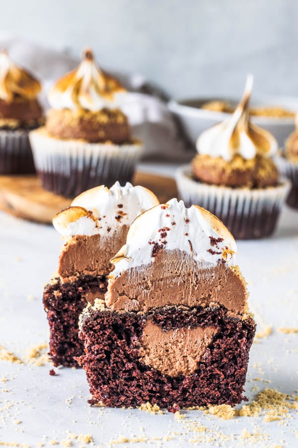 vegan smores cupcakes cut in half with chocolate filling exposed