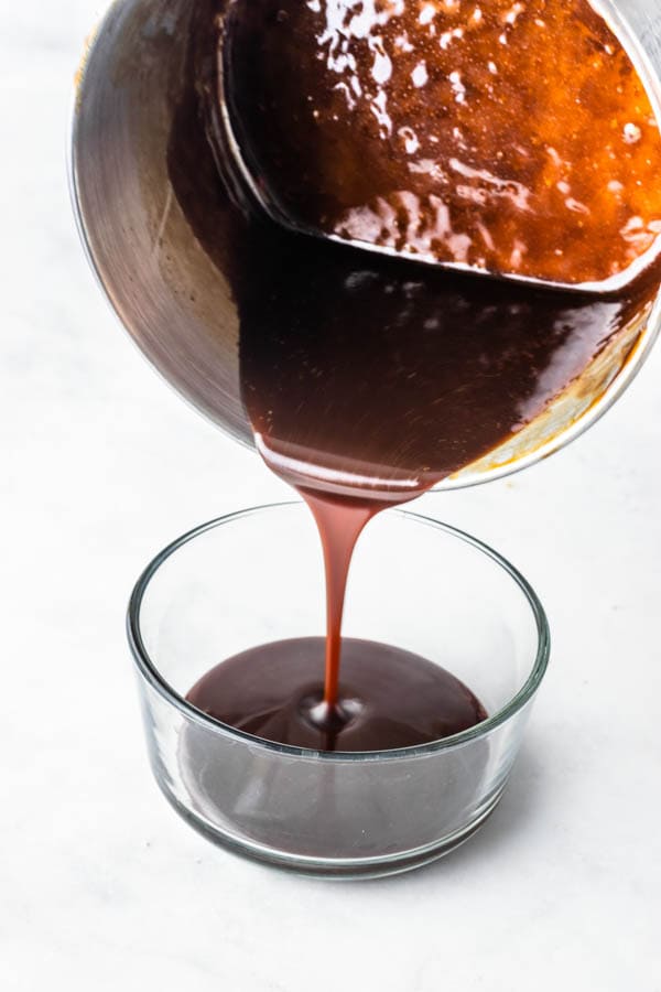 pouring caramel sauce into a bowl
