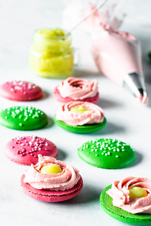 key lime raspberry macarons showing the lime curd and the raspberry buttercream filling