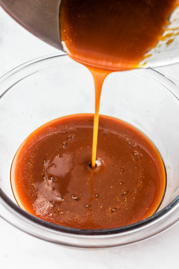 pouring vegan caramel sauce in a bowl