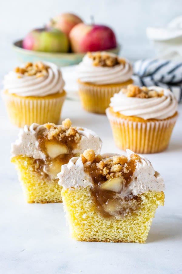 Apple Crisp Cupcakes with cinnamon cream cheese frosting, filled with apple pie filling cut in half