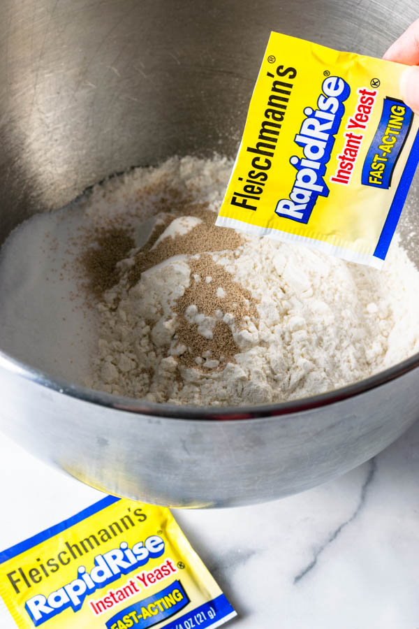 mixing dry ingredients with yeast to make sweet rolls dough