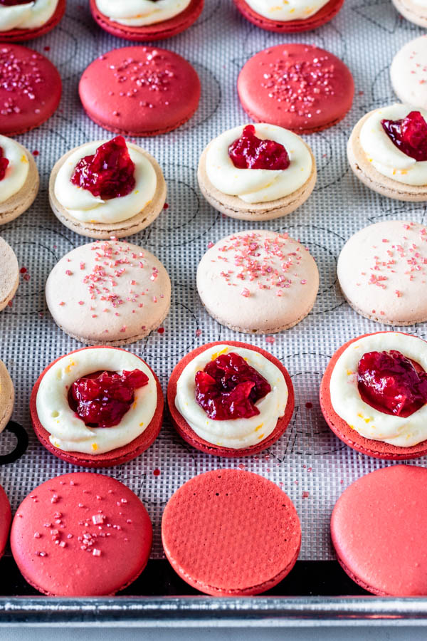 macarons filled with orange buttercream and cranberry sauce