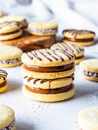 Alfajor Recipe filled with dulce de leche drizzled with melted chocolate