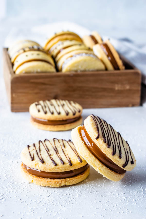 Alfajor Recipe filled with dulce de leche drizzled with melted chocolate