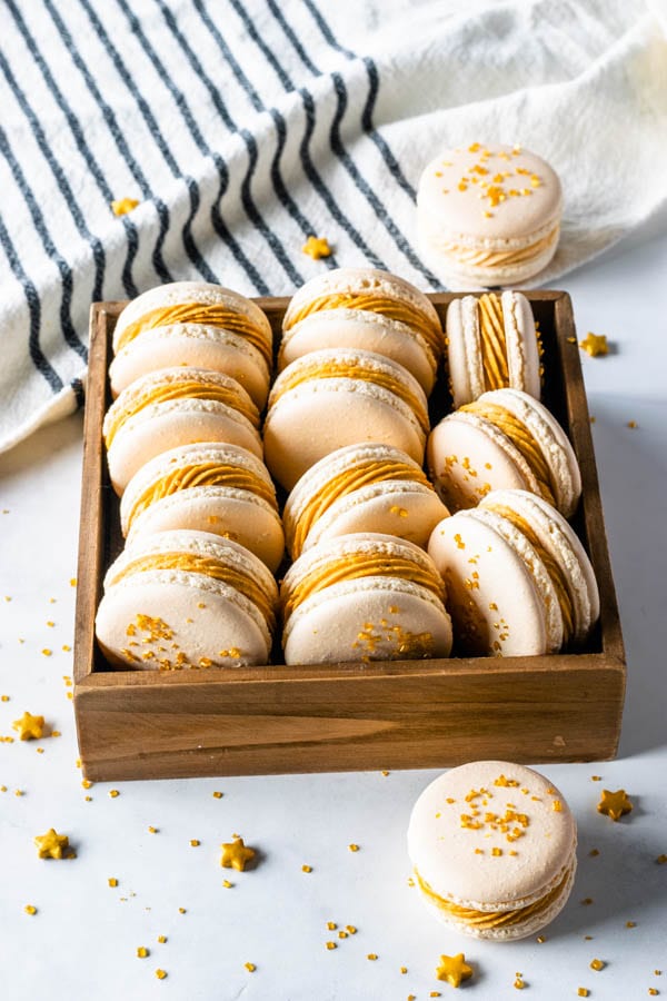 Butterbeer Macarons with Butterbeer buttercream and butterscotch ganache filling topped with gold sugar