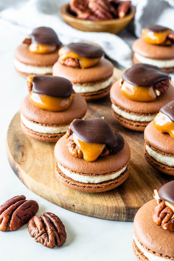 Pecan Turtle Macarons topped with a pecan turtle candy