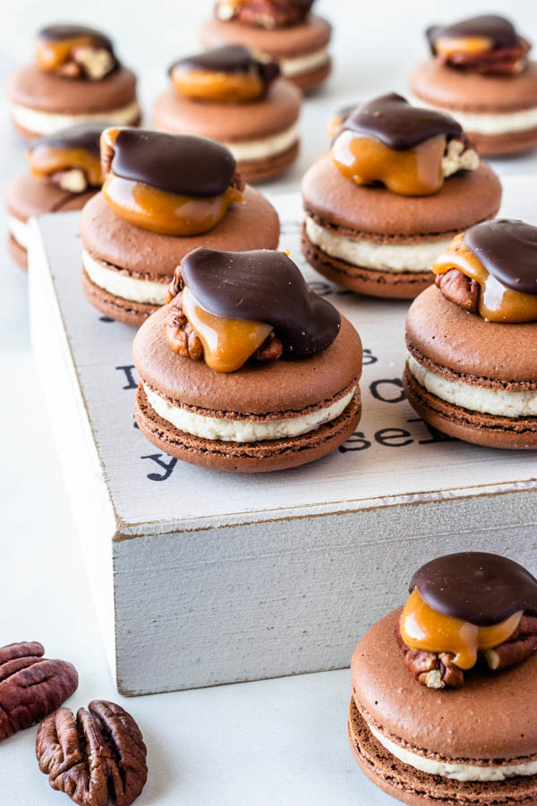 Pecan Turtle Macarons topped with a pecan turtle candy