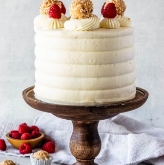 Raspberry Coconut Cake topped with raspberries and coconut fudge truffles