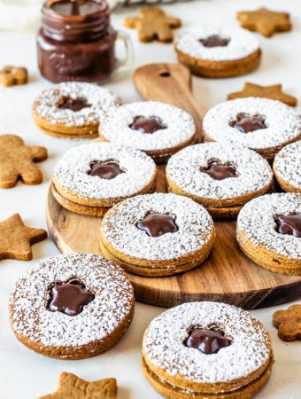 Vegan Gingerbread Cookies with Fudge Filling dusted with powdered sugar