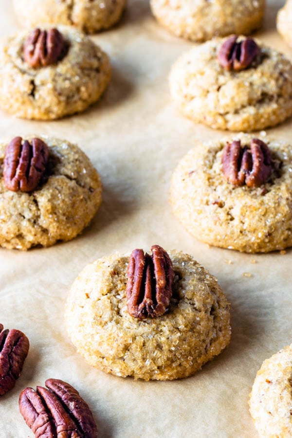Vegan Pecan Cookies with a touch of bourbon topped with a pecan