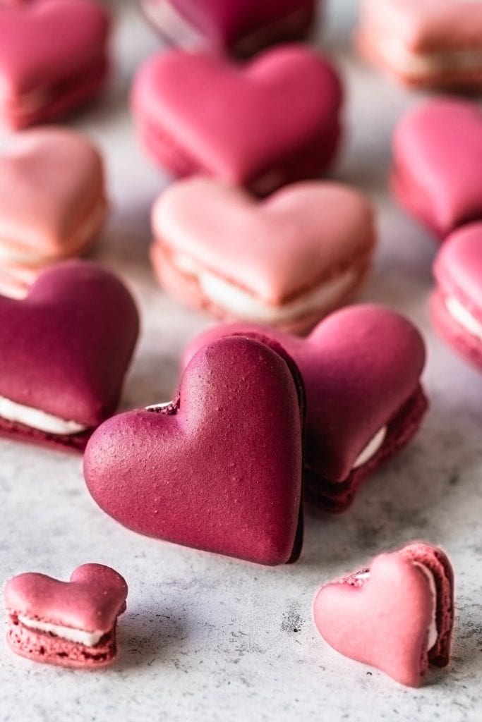 burgundy and pink Heart Macarons in a box.