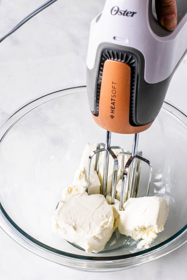 creaming cream cheese with an electric mixer