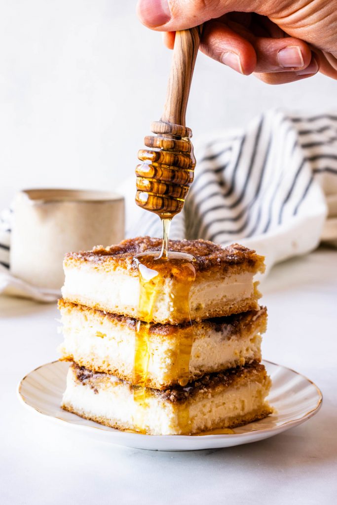 Sopapilla Cheesecake Bars with honey drizzle