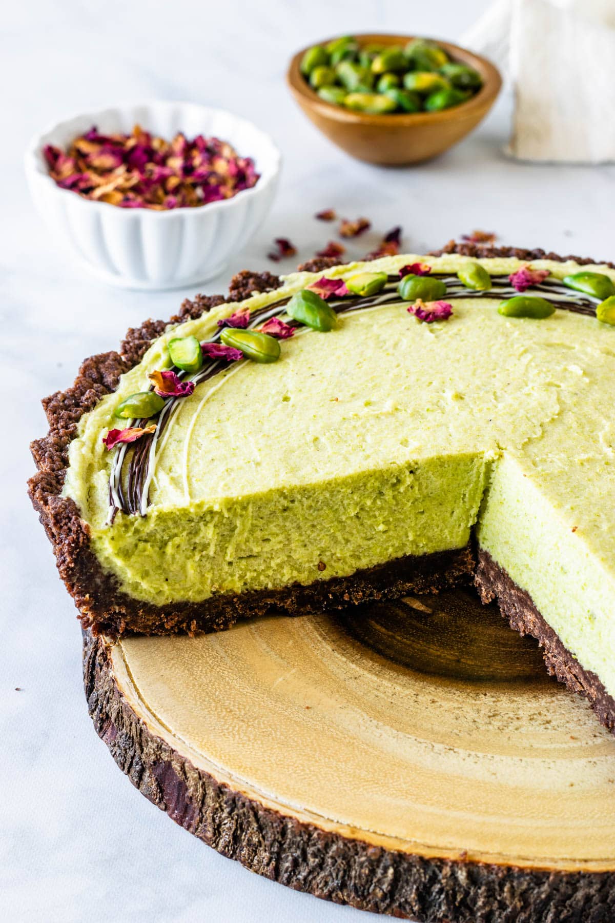 No Bake Pistachio Pie topped with pistachios drizzled chocolate and dried rose petals