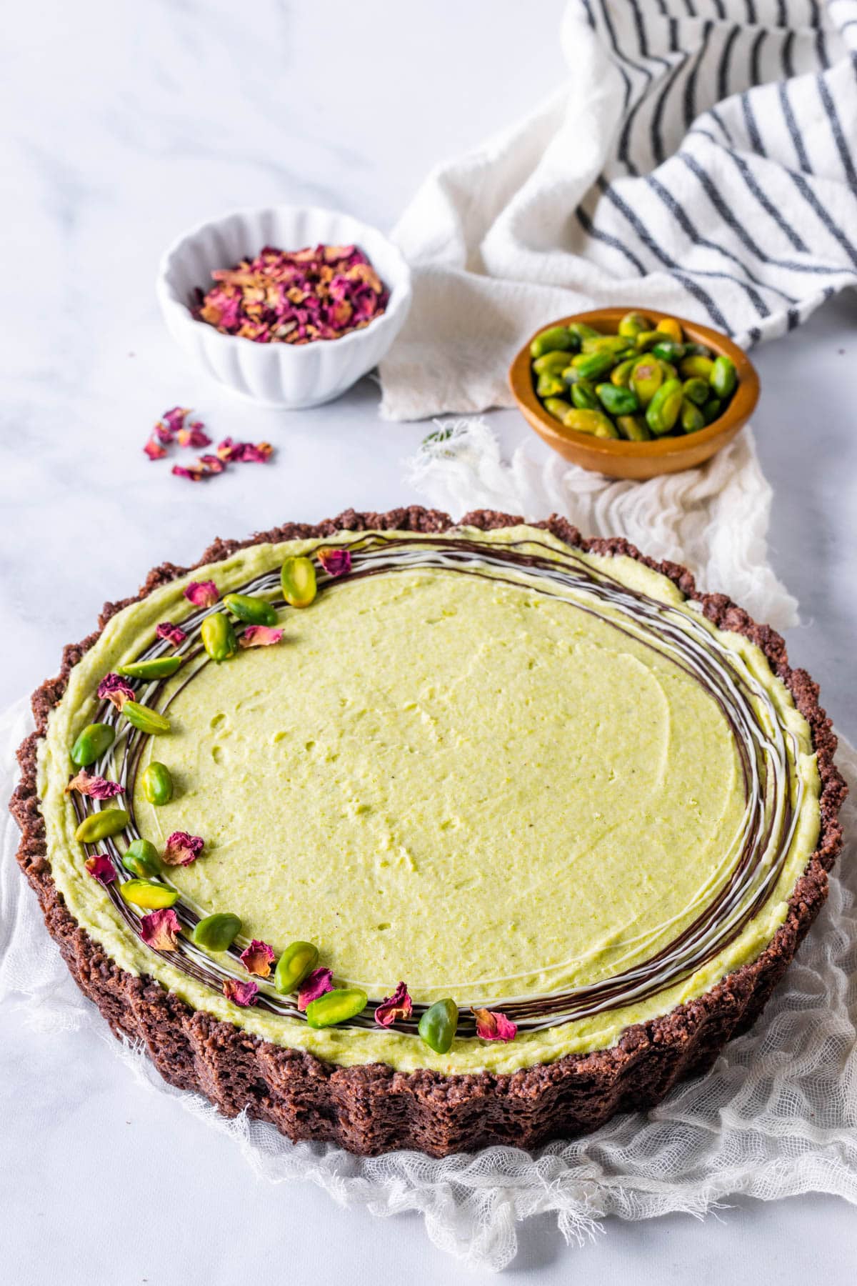 No Bake Pistachio Pie topped with pistachios drizzled chocolate and dried rose petals