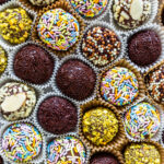 brigadeiros coated in sprinkles, chopped pistachios, chopped almonds.