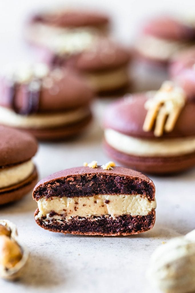 chocolate macarons with peanut butter filling chopped in half