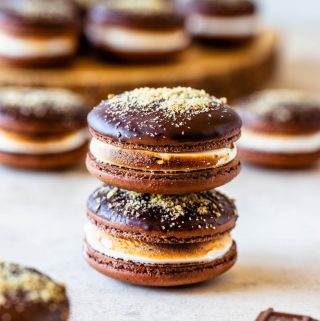 S'mores Macarons dipped in chocolate topped with graham cracker crumbs filled with toasted marshmallow