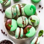 Mint Chocolate Macarons dipped in chocolate filled with ganache in a plate
