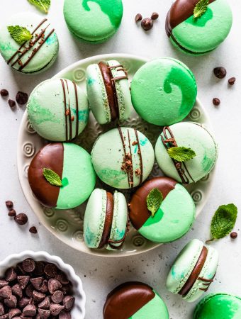 Mint Chocolate Macarons dipped in chocolate filled with ganache in a plate