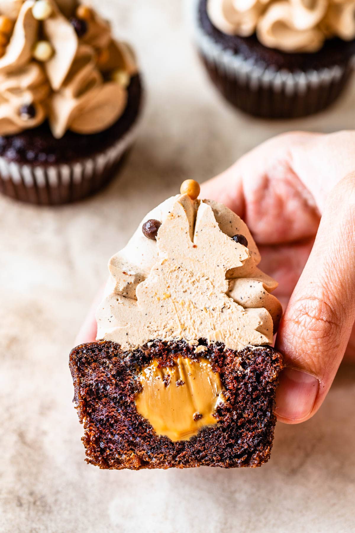 Dulce de Leche Mocha Cupcakes sliced in half showing the filling which is dulce de leche