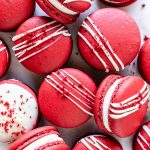 Red Velvet Macarons drizzled with white chocolate topped with red velvet cake crumbs