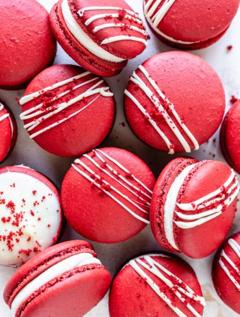 Red Velvet Macarons drizzled with white chocolate topped with red velvet cake crumbs