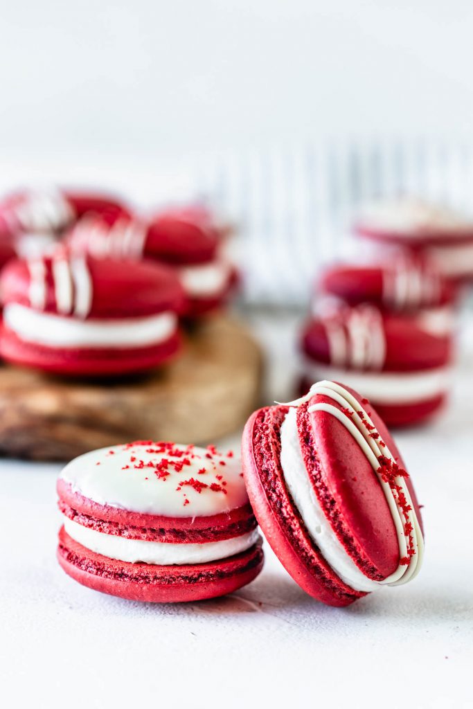 Red Velvet Macaron recipe drizzled with white chocolate topped with red velvet cake crumbs