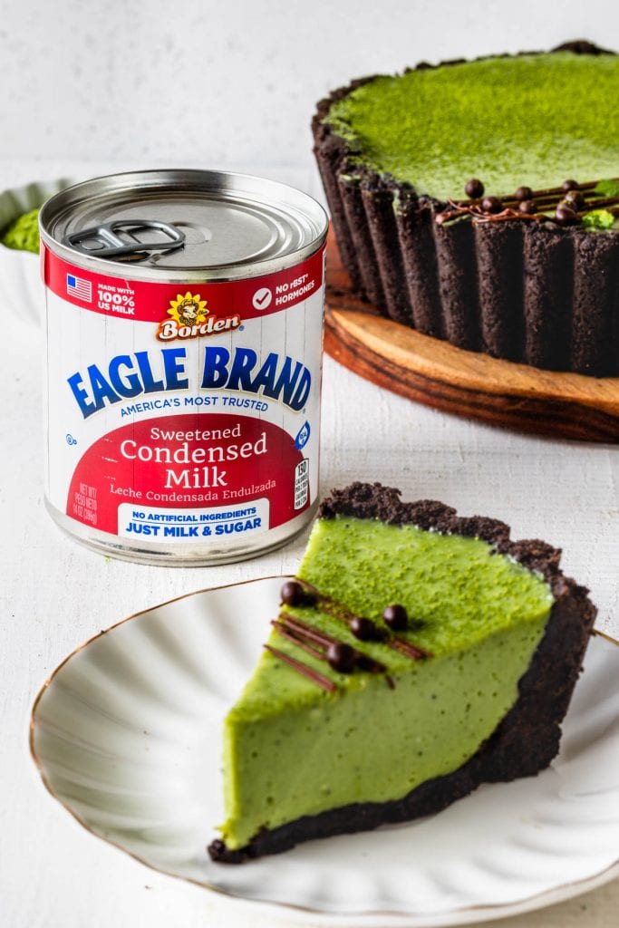 Matcha Pie with oreo crust and drizzled with chocolate and callebaut crispearls sliced with a can of Eagle Brand® condensed milk in the back