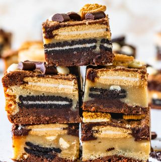 bars layered with blondie and brownie batter and oreos and golden oreos