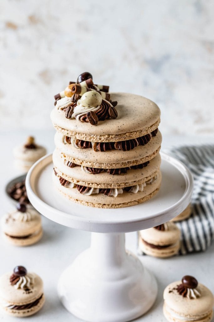 macaron shells filled with mocha and espresso frosting, topped with frosting, chocolate covered espresso beans.