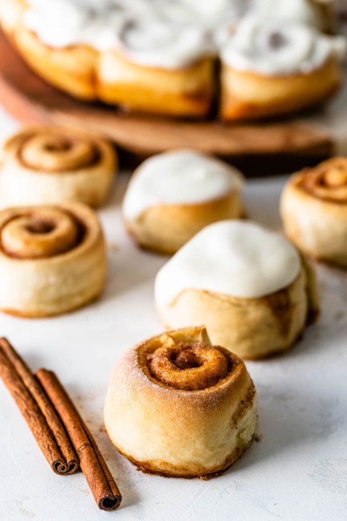 Mini Cinnamon Rolls  without glaze, with some rolls with glaze on the back.