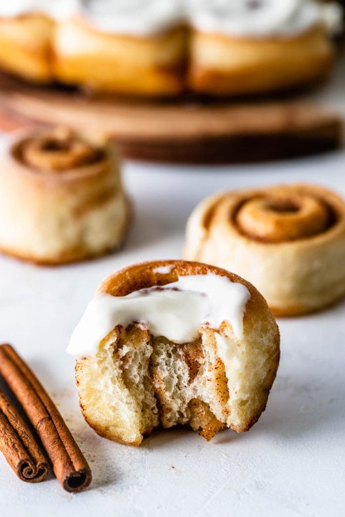 mini cinnamon roll with a bite taken out.