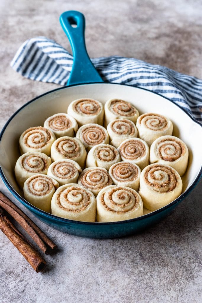 Mini Cinnamon Rolls before baking, placed in a blue skillet.