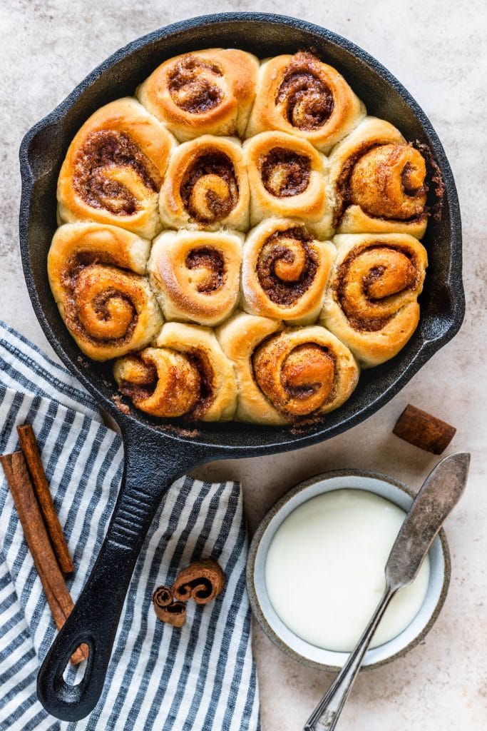 cinnamon rolls in a skillet without glaze on top.