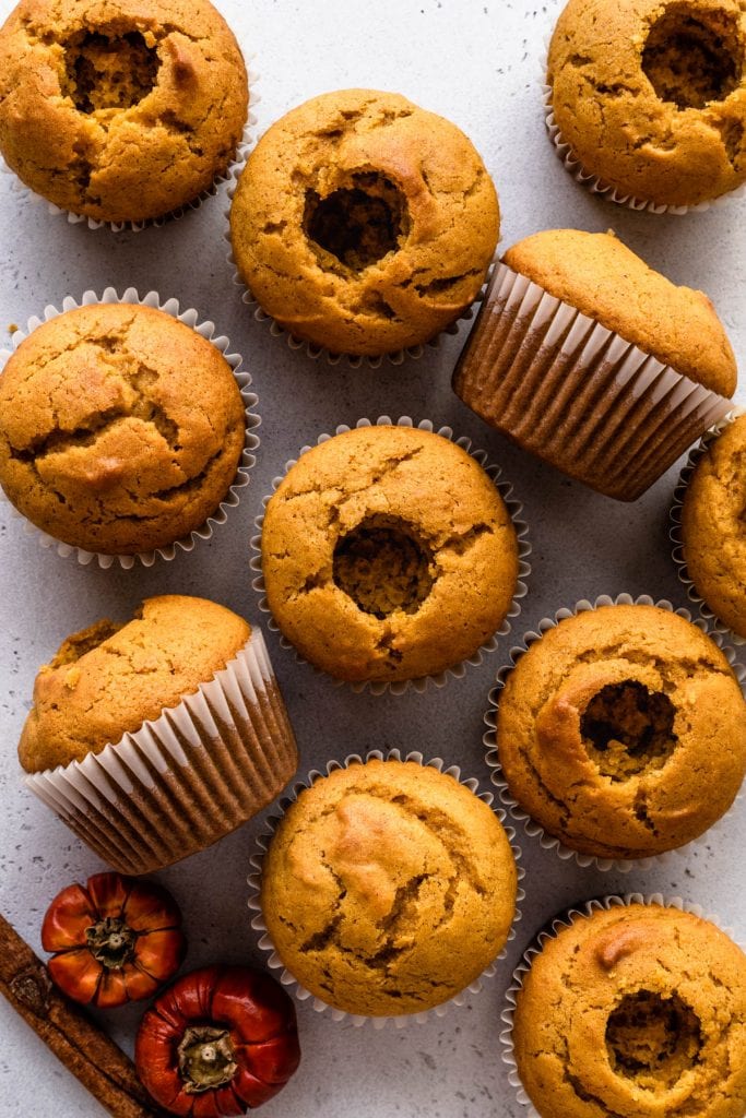 pumpkin cupcakes with holes in the middle.