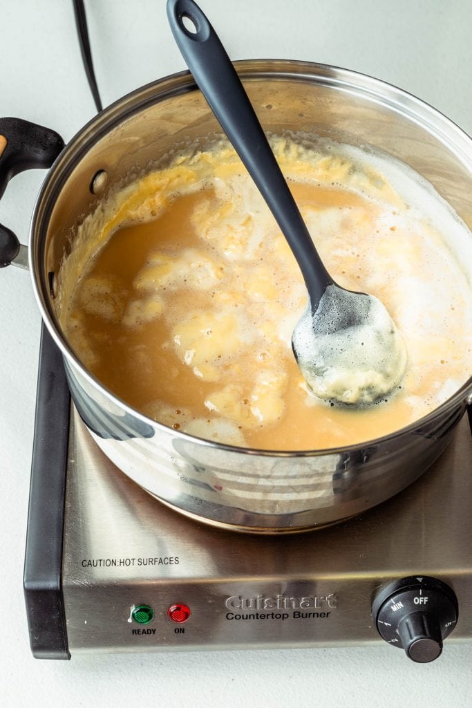 boiling sugar and milk in a saucepan.