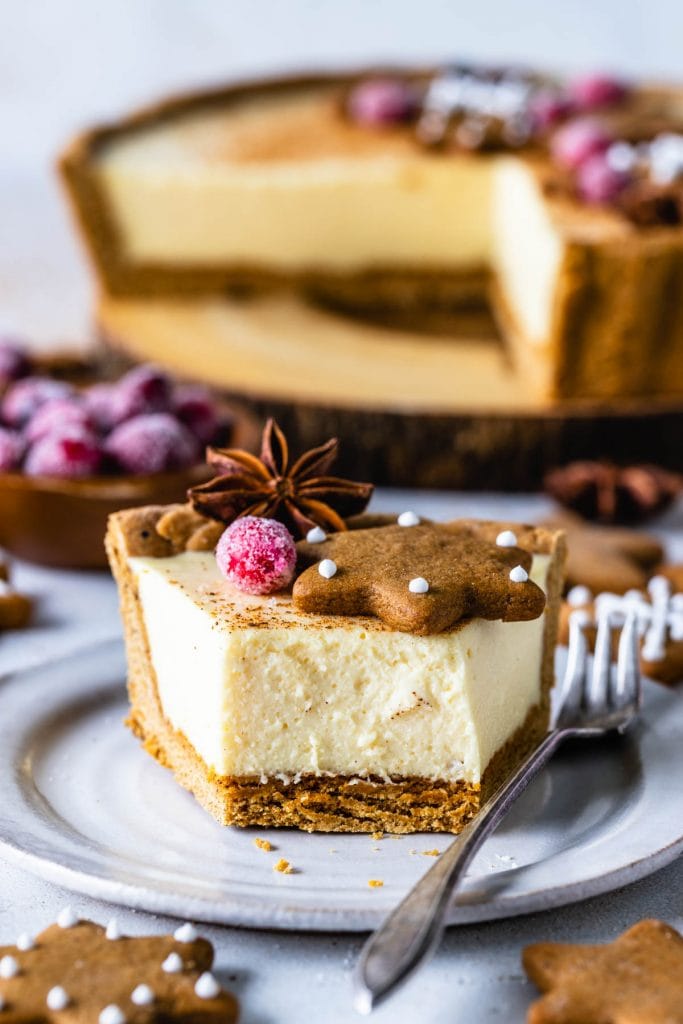 slice of Eggnog Pie topped with gingerbread cookies, rosemary sprigs and sugared cranberries.