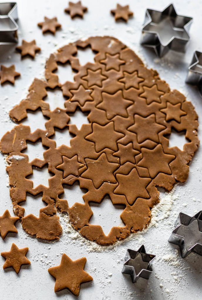 gingerbread cookie dough rolled out and cut into stars.
