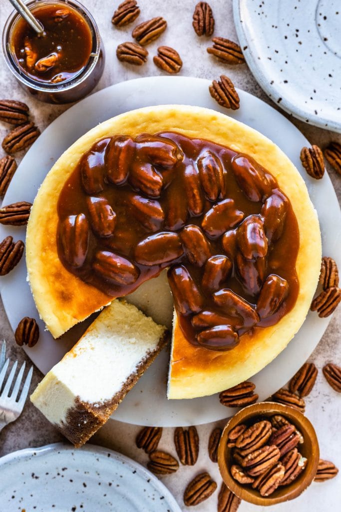 cheesecake seen from the top, topped with pecan caramel sauce.