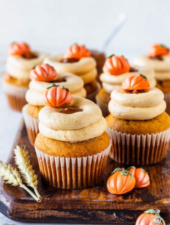 Dulce de Leche Pumpkin Cupcakes topped with a little pumpkin and with a russian buttercream.